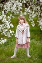 Beautiful preteen girl with long blond hair enjoy spring apple blooming. Little preschool girl in garden tree flowers. Springtime Royalty Free Stock Photo