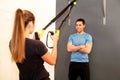 Sportswoman training with trx resistance band with trainer Royalty Free Stock Photo