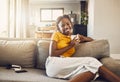 Beautiful, pretty and happy woman relaxing, drinking coffee and resting on the couch in the living room alone at home Royalty Free Stock Photo