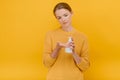 Beautiful pretty woman casually dressed uses an antiseptic sanitizer or liquid soap on her hand , looks on hands, having doubtful Royalty Free Stock Photo