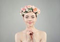 Beautiful pretty woman in rose flowers crown portrait. Healthy spa model with clear skin and manicured nails Royalty Free Stock Photo