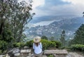 Beautiful pretty woman sitting at the top of the single tree hill in Nuwara Eliya Royalty Free Stock Photo