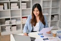 Beautiful Asian businesswoman working on financial report and using laptop art her desk Royalty Free Stock Photo