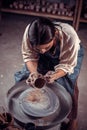 Stylish pottery girl making ceramic pot on the pottery wheel . Handcraft. Royalty Free Stock Photo