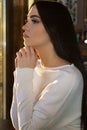 Beautiful profile brunette woman face in white sweater