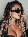 Beautiful blonde alternative woman with curly hair and sunglasses