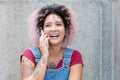 Beautiful punk girl with pink hair laughing at phone Royalty Free Stock Photo