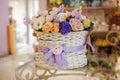Beautiful purple bouquet of mixed flowers in basket on table