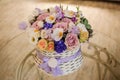 Beautiful purple bouquet of mixed flowers in basket on table Royalty Free Stock Photo