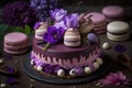 Beautiful purple cake decoraited of fresh flowers, macaroons and meringue.