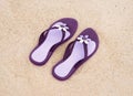 Beautiful purple flip-flops on the beach