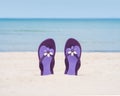 Beautiful purple flip-flops on the beach