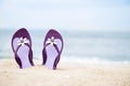 Beautiful, purple flip-flops on the beach