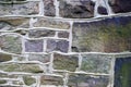 Beautiful purple and green fieldstones in old Pennsylvania masonry wall.