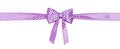 Purple polkadot ribbon with bow isolated on white background.