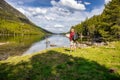 Beautiful Pyrenees mountain landscape, nice lake with tourist man looking a map from Spain, Catalonia