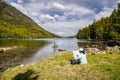 Beautiful Pyrenees mountain landscape, nice lake with tourist woman looking a map from Spain, Catalonia