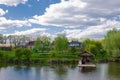 Beautiful quiet lake with a wooden gazebo in a rural cottage village. Country holiday Royalty Free Stock Photo