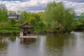 Beautiful quiet lake with a wooden gazebo in a rural cottage village. Country holiday Royalty Free Stock Photo