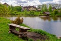 Beautiful quiet lake with a wooden gazebo in a rural cottage village. Country holiday. Pleasant weekend in nature Royalty Free Stock Photo