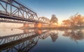 Beautiful railroad bridge and river in fog at sunrise in autumn