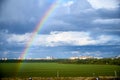 beautiful rainbow against the green meadow. color