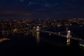 Aerial drone photo - Rainbow Bridge and the skyline of Tokyo at night. Capital city of Japan. Royalty Free Stock Photo