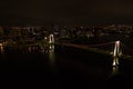 Aerial drone photo - Rainbow Bridge and the skyline of Tokyo at night. Capital city of Japan. Royalty Free Stock Photo