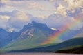 Beautiful rainbow lies over Glacial mountains.