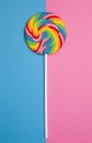 Beautiful Rainbow Lollipop on a blue and pink background Royalty Free Stock Photo