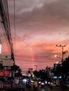 A beautiful rainbow in the middle of a crowded city.