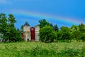 Rainbow over Red Barn with Silos Royalty Free Stock Photo