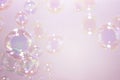 Beautiful rainbow pink soap bubbles float background.