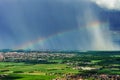 Beautiful rainbow with rainy clouds, colorful summer view