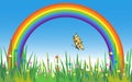 Beautiful Rainbow Scenery with Grass, Flowers and Butterfly. Royalty Free Stock Photo