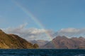 Rainbow over the rocky shoreline of Kodiak, Alaska