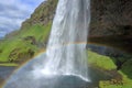Seljalandsfoss Waterfall with Beautiful Rainbow in Southern Iceland Royalty Free Stock Photo