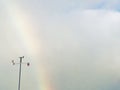 Rainbow in the sky with weathervane.
