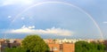 Beautiful rainbow spanning across the sky above urban rooftops in the Bronx, New York, NYC