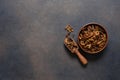 Beautiful raisins in a plate on a dark concrete background with place for text. View from above