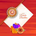 Beautiful rakhi wristband and gift boxes decorated on red text