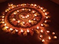 Rangoli with flowers and Diya.