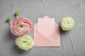 Beautiful ranunculus flowers with envelope Royalty Free Stock Photo