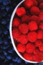 Beautiful raspberries fruit background. Ripe sweet raspberry in white bowl. Close up, top view, high resolution product. Royalty Free Stock Photo