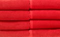 Beautiful red bath towels tidily folded on shelves in department store used as pattern background Royalty Free Stock Photo