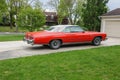 A beautiful red Buick LeSabre convertible parked in a driveway