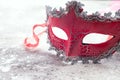 Beautiful red carnival mask for carnival holiday background concept on stone, Human duplicity concept