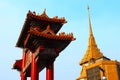 Beautiful red Chinese gate and a golden pagoda at Chinatown in Bangkok, Thailand Royalty Free Stock Photo