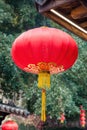 Beautiful red Chinese lantern hanging on eaves of traditional Chinese old style wood building to decorated the Chinese festive
