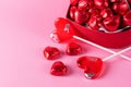 Beautiful Red Chocolate Hearts Candies in Red Box and Red Lollipop Shape of Heart on Pink Background St Valentine Day Background